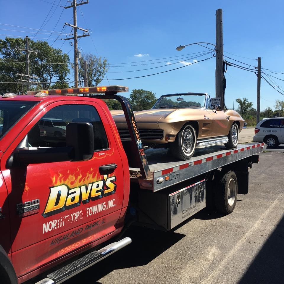 A red tow truck that says dave 's on it