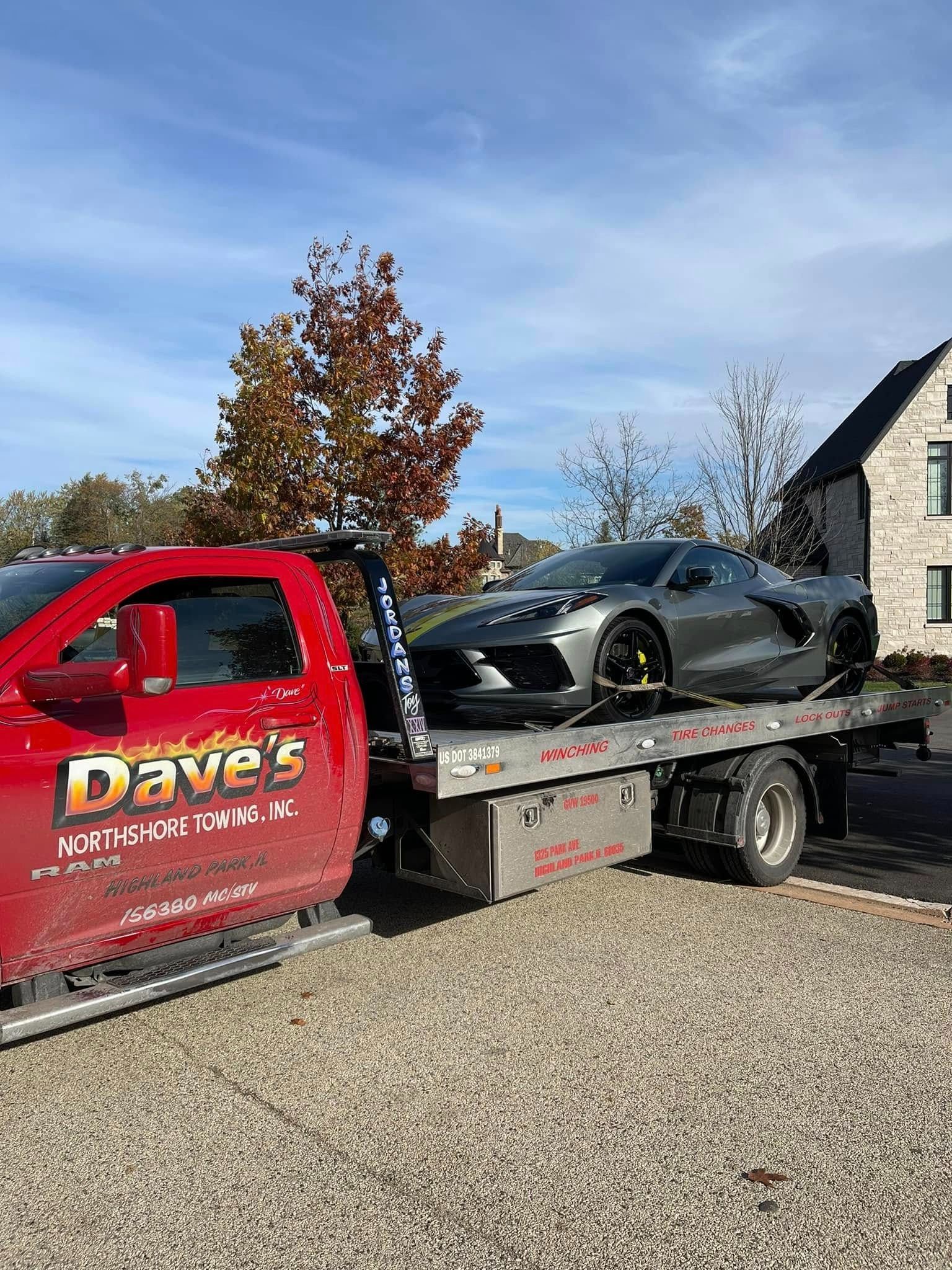 A car is being towed by a tow truck.