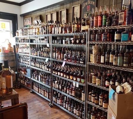 A store filled with lots of bottles of liquor including jim beam