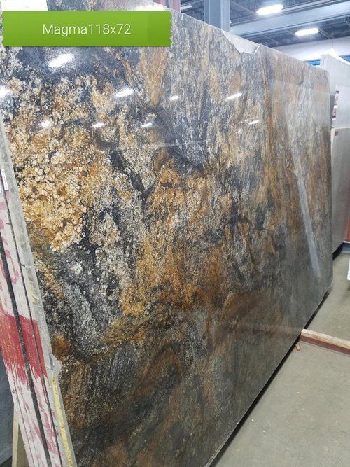 A large slab of granite is sitting in a warehouse.