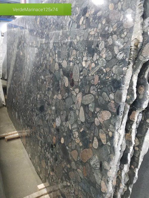 A stack of granite slabs sitting on top of each other in a warehouse.