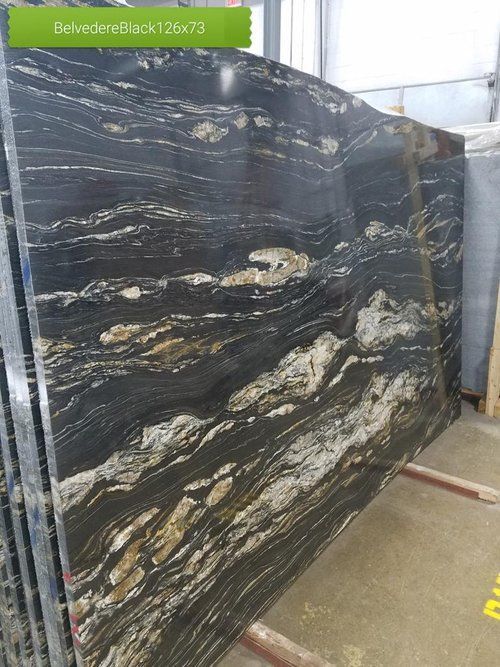 A black granite slab is sitting on top of a metal rack.
