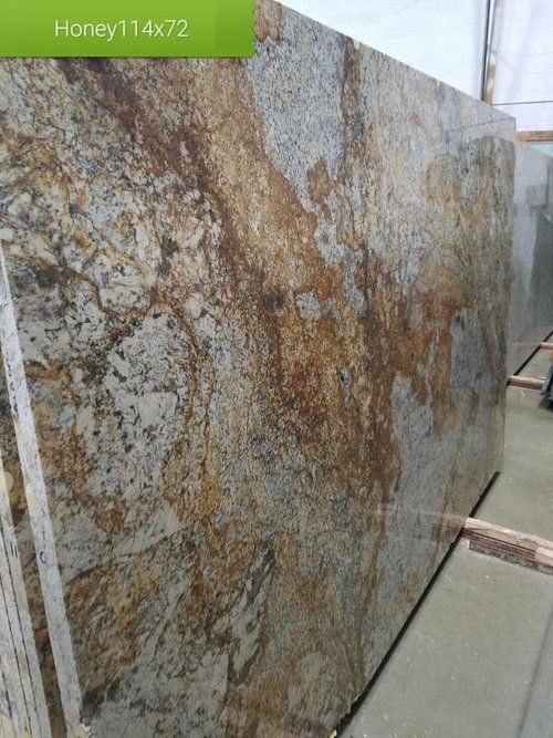 A large slab of granite is sitting on top of a concrete floor.