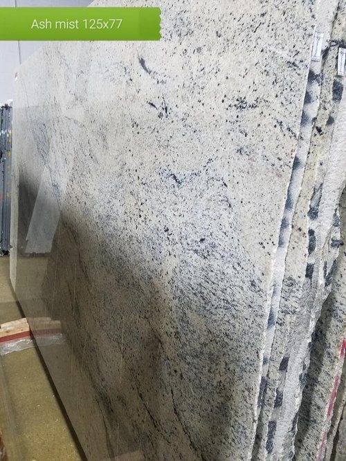 A stack of white granite slabs sitting on top of each other.