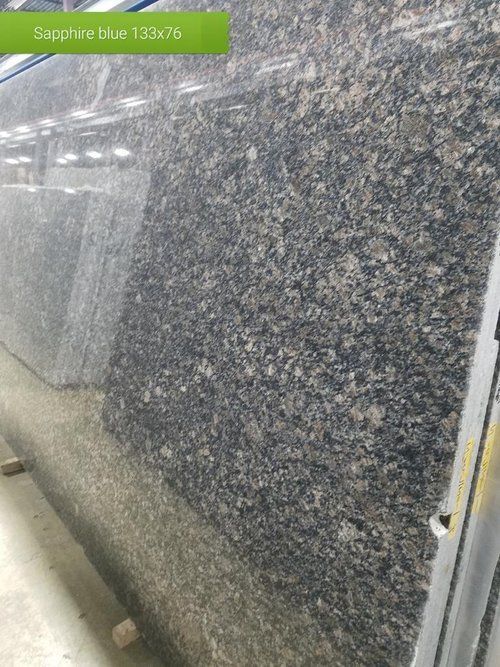 A close up of a sapphire blue granite slab in a warehouse.
