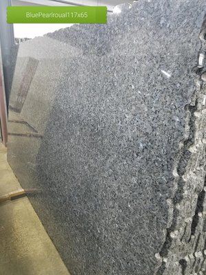 A large piece of granite is sitting on top of a wooden table.
