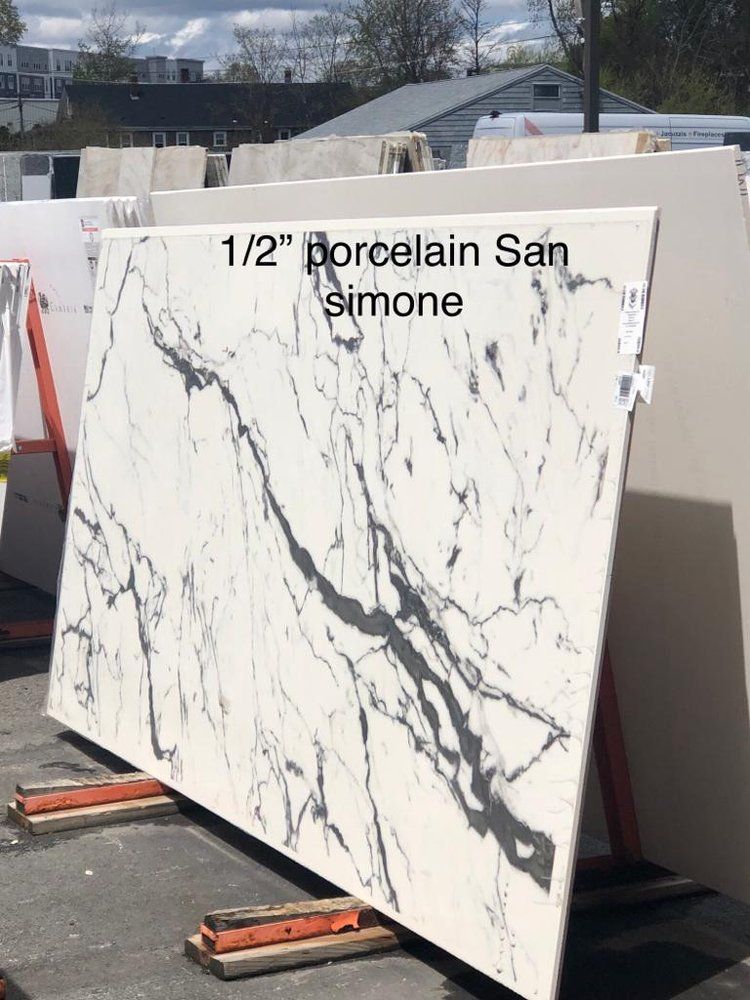 A white and black marble slab is sitting on a rack.