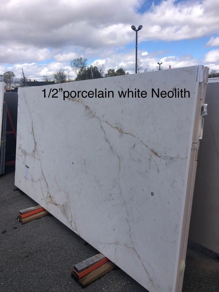A large white slab of porcelain is sitting on a wooden stand.