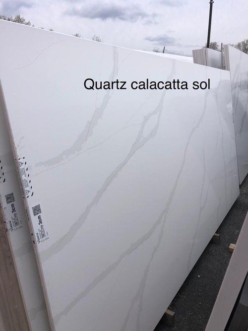 A stack of white quartz slabs sitting on top of each other.