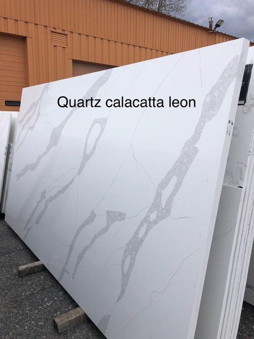 A large white slab of quartz calacatta leon