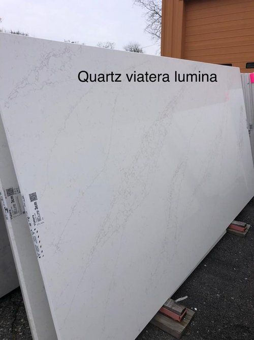 A large white slab of quartz is sitting on the ground.