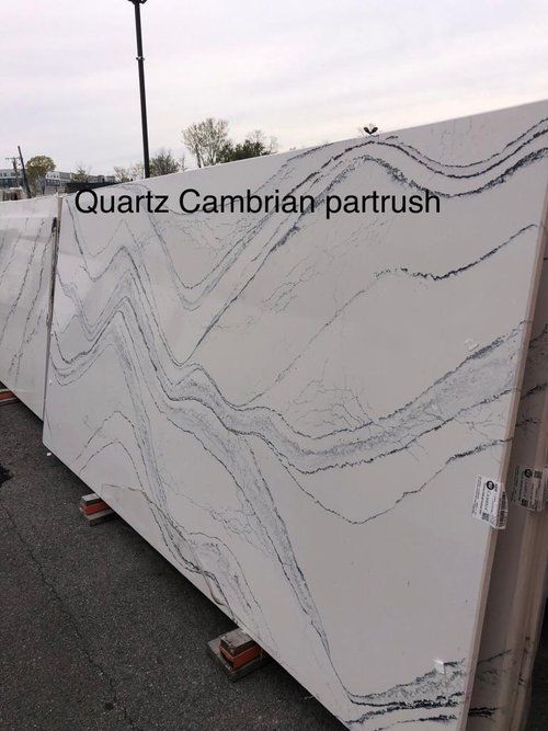 A row of quartz slabs sitting on top of each other in a parking lot.