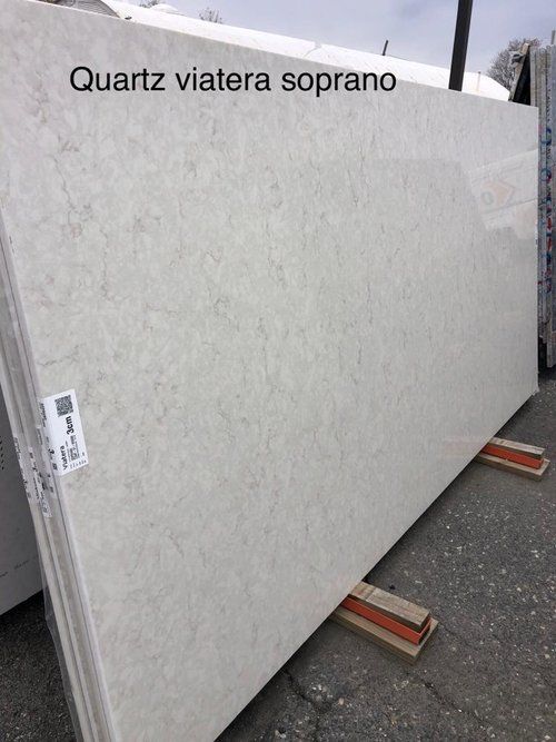 A large slab of quartz is sitting on a wooden stand.