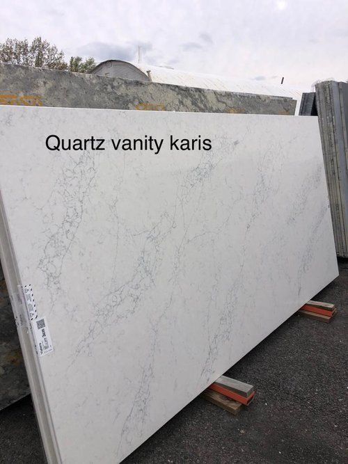 A large white slab of quartz vanity kars is sitting on a pallet.