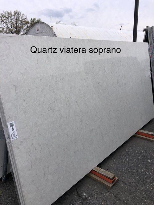 A large white quartz slab is sitting on a wooden pallet.