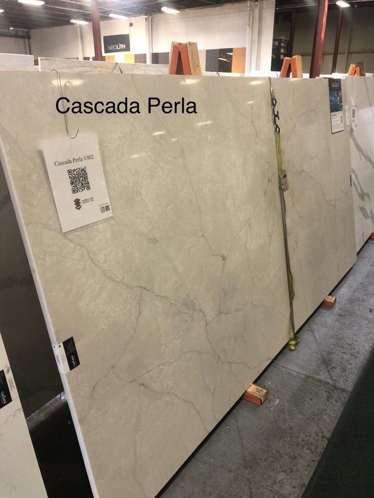 A large slab of cascada perla is sitting in a warehouse
