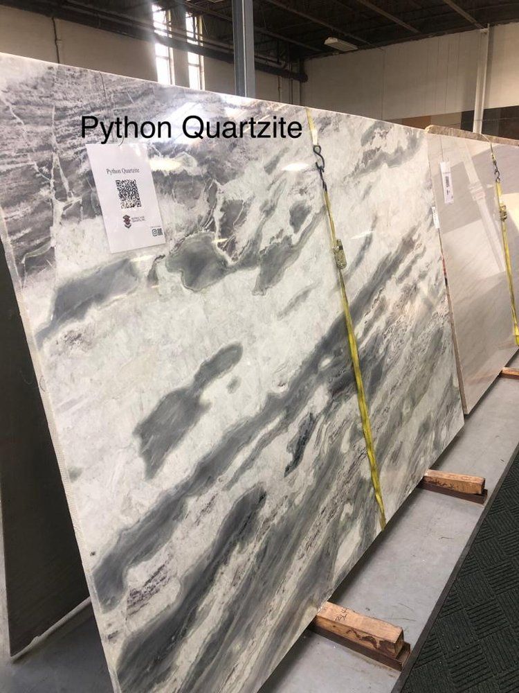 A large slab of python quartzite is sitting on a rack in a warehouse.
