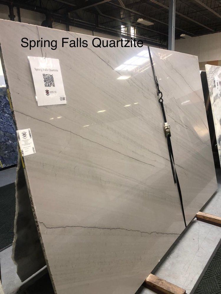 A display of spring falls quartz slabs in a store.