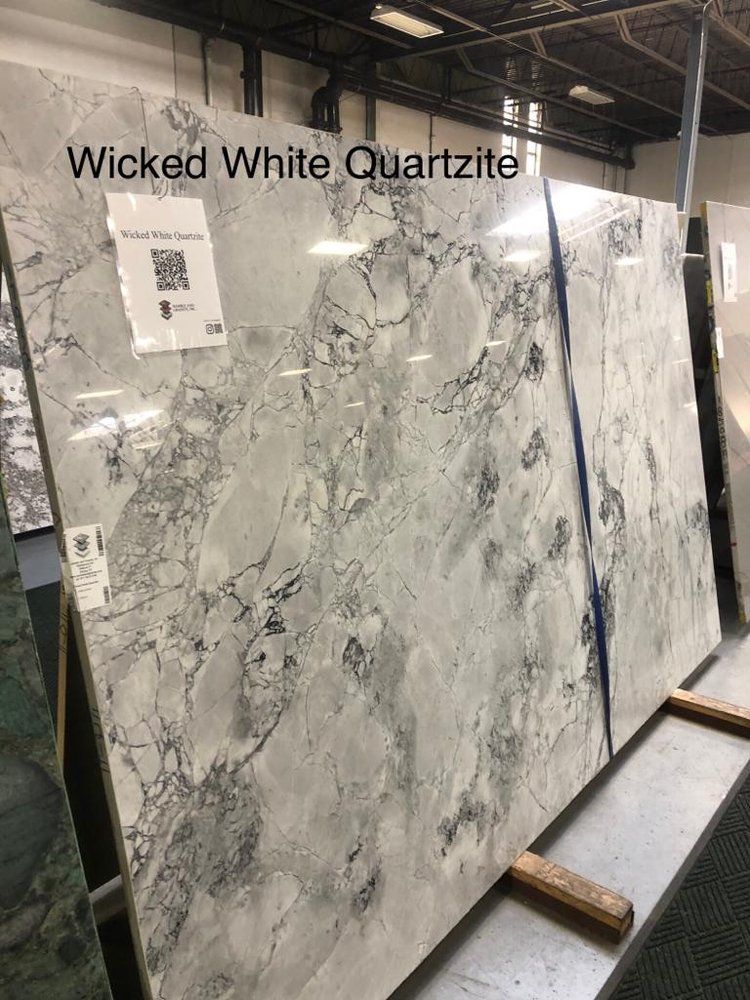 A large slab of wicked white quartzite is sitting on top of a table.