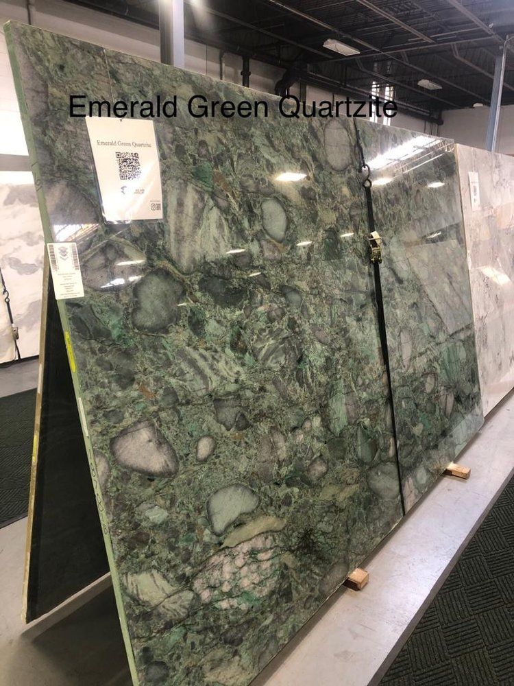 A display of emerald green quartz slabs in a store.
