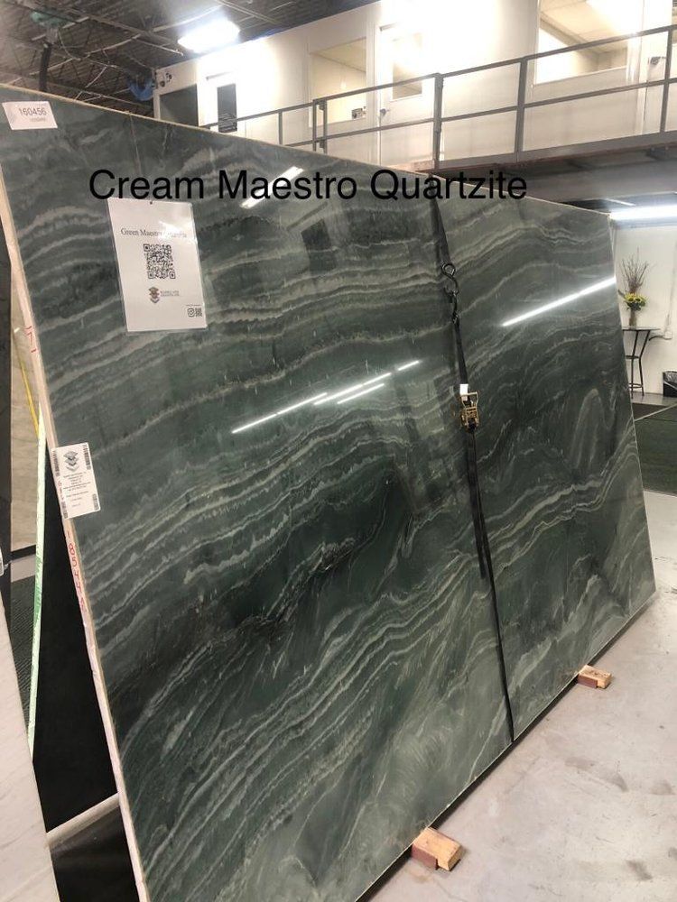 A stack of green granite slabs sitting on top of each other in a room.