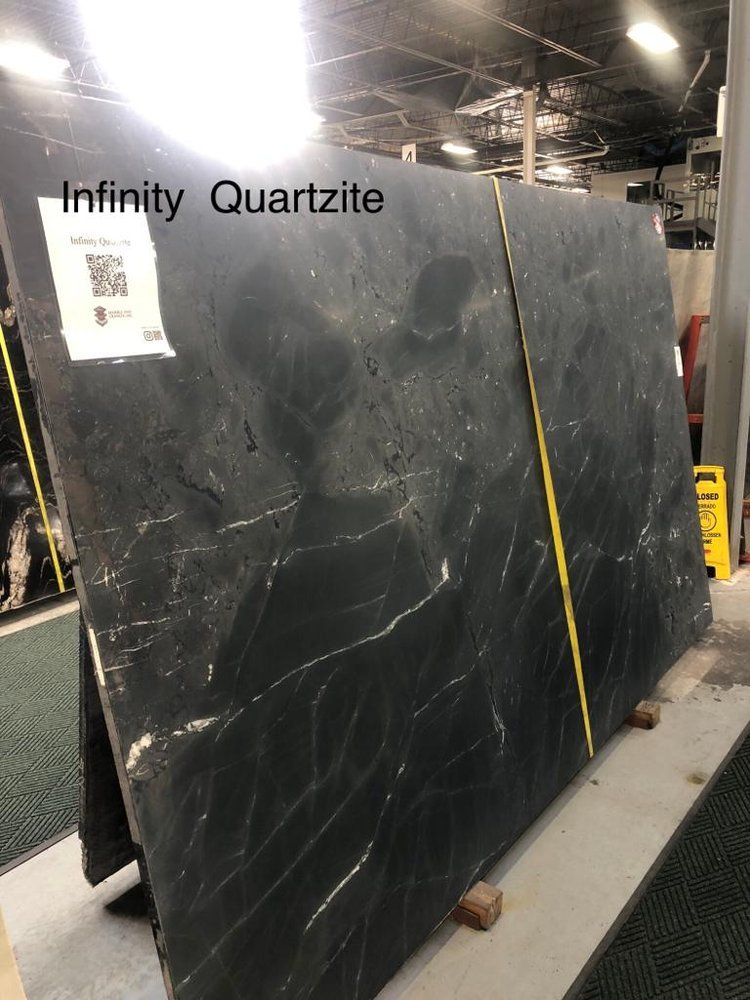 A large slab of infinity quartzite is sitting on a table in a warehouse.