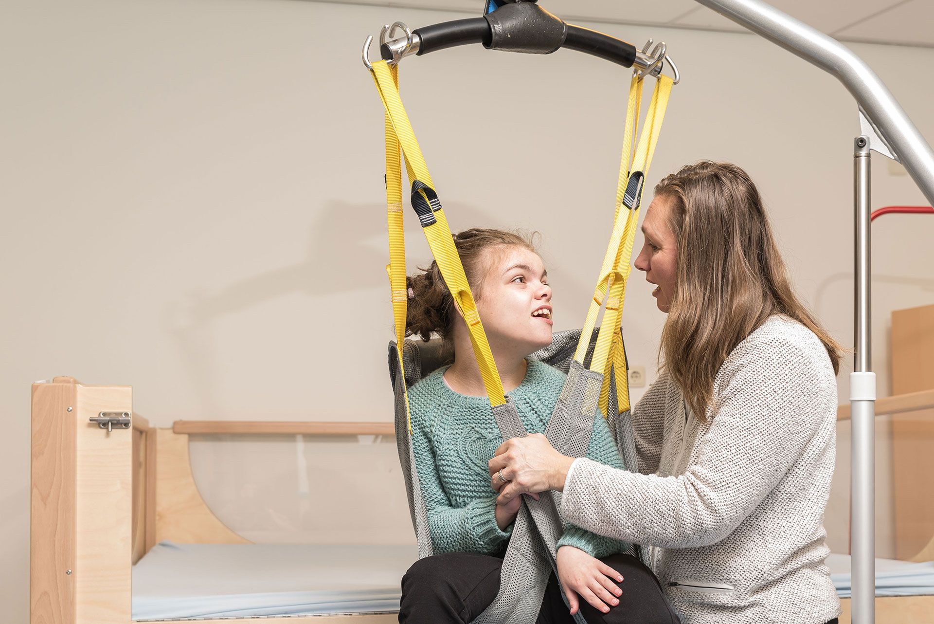disabled person being lifted into a wheelchair
