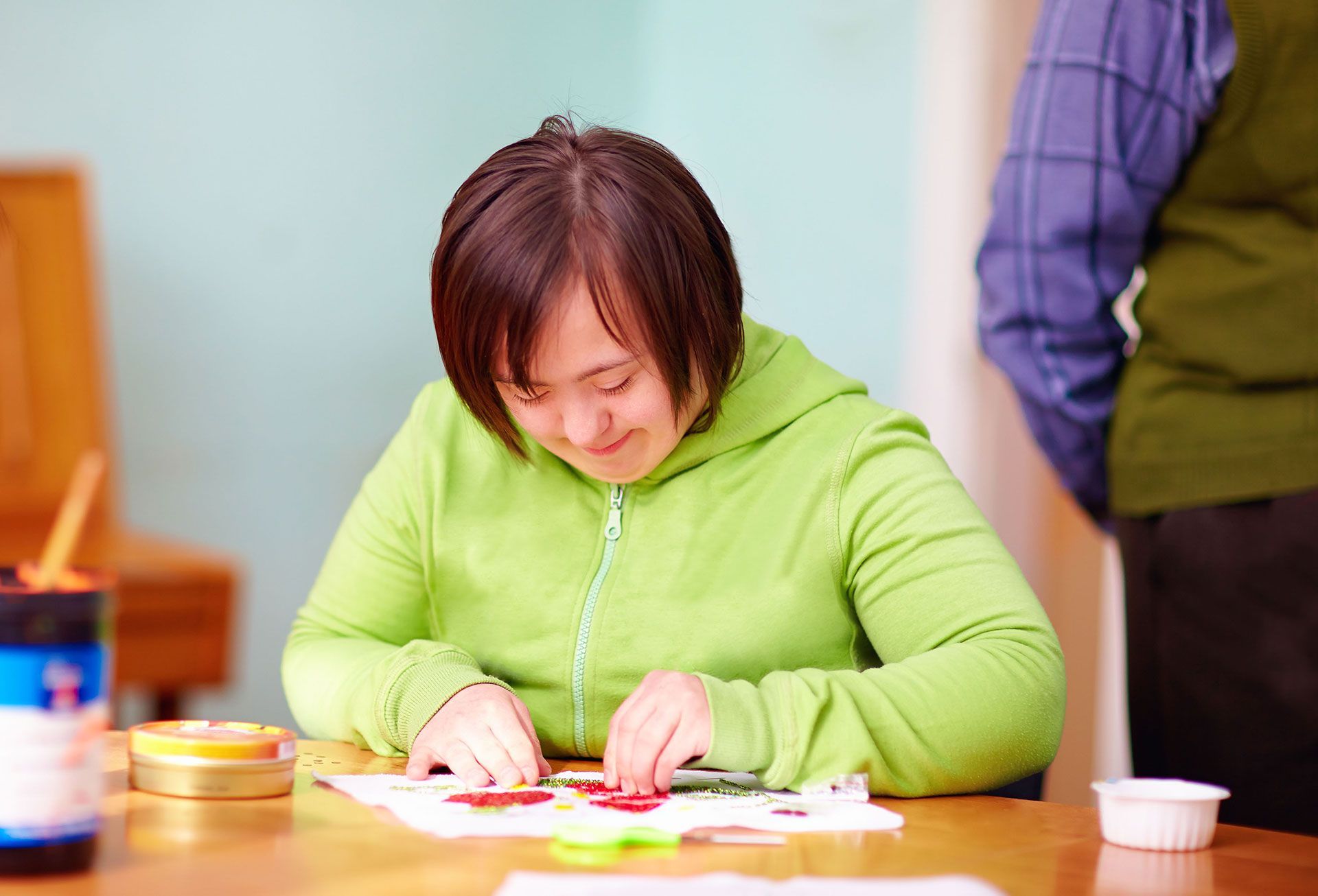 young adult woman with disability engaged in craftsmanship