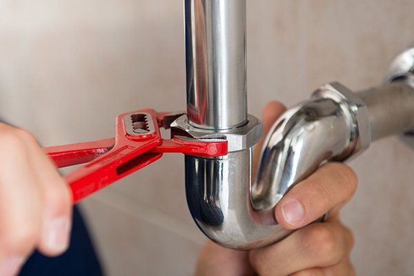 Learn More About Plumbing Plumber fixing pipe with wrench