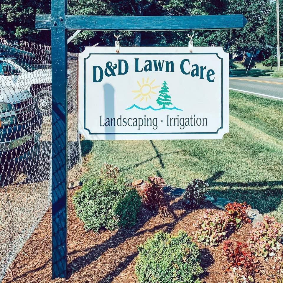 Sign for D&D Lawn Care; shows logo of a sun and pine tree, services include landscaping and irrigation.