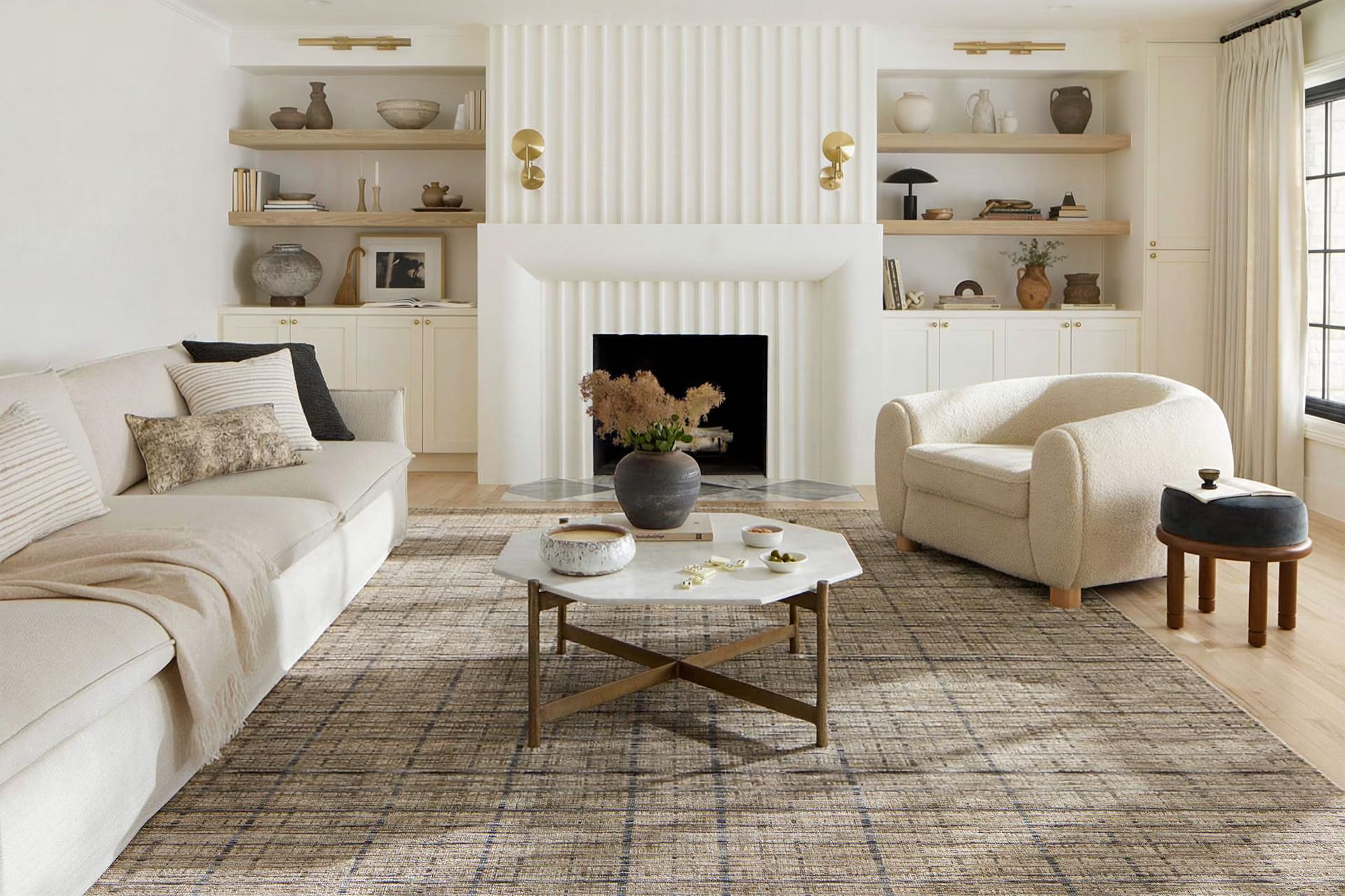 Elegant beige living room with sectional sofa, armchair, coffee table, fireplace, and built-in shelves