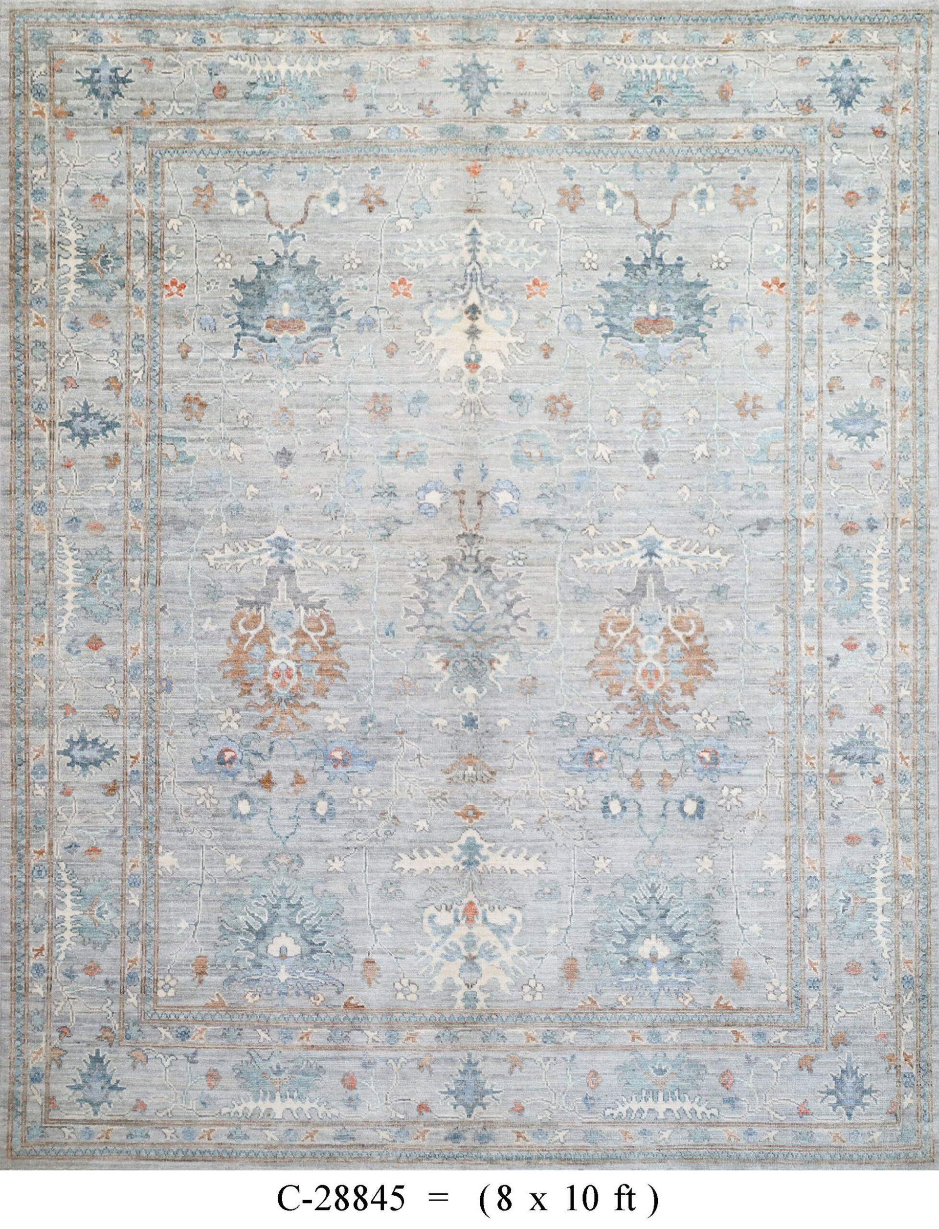Faded pale blue and beige vintage rug with ornate floral medallions and border pattern.