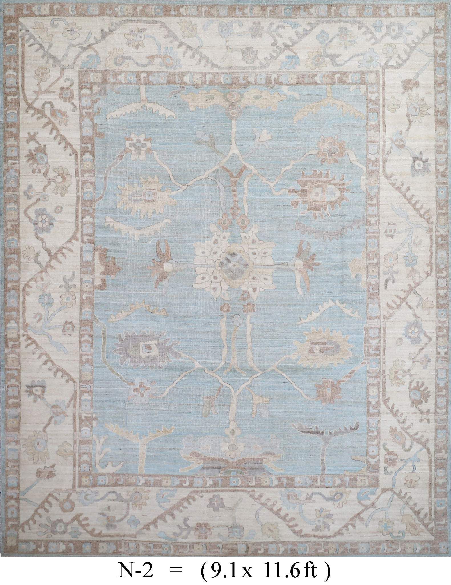 Light blue vintage rug with cream border and floral medallion pattern