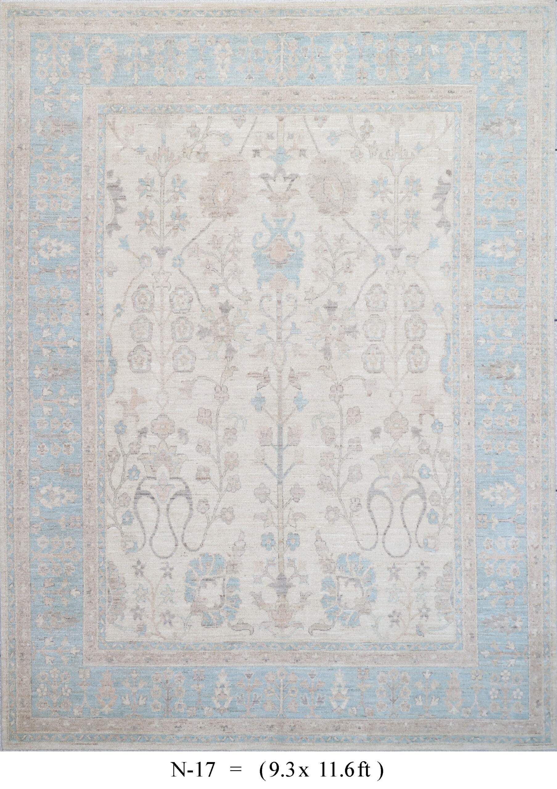 Faded blue and beige patterned rug with a central medallion and floral border