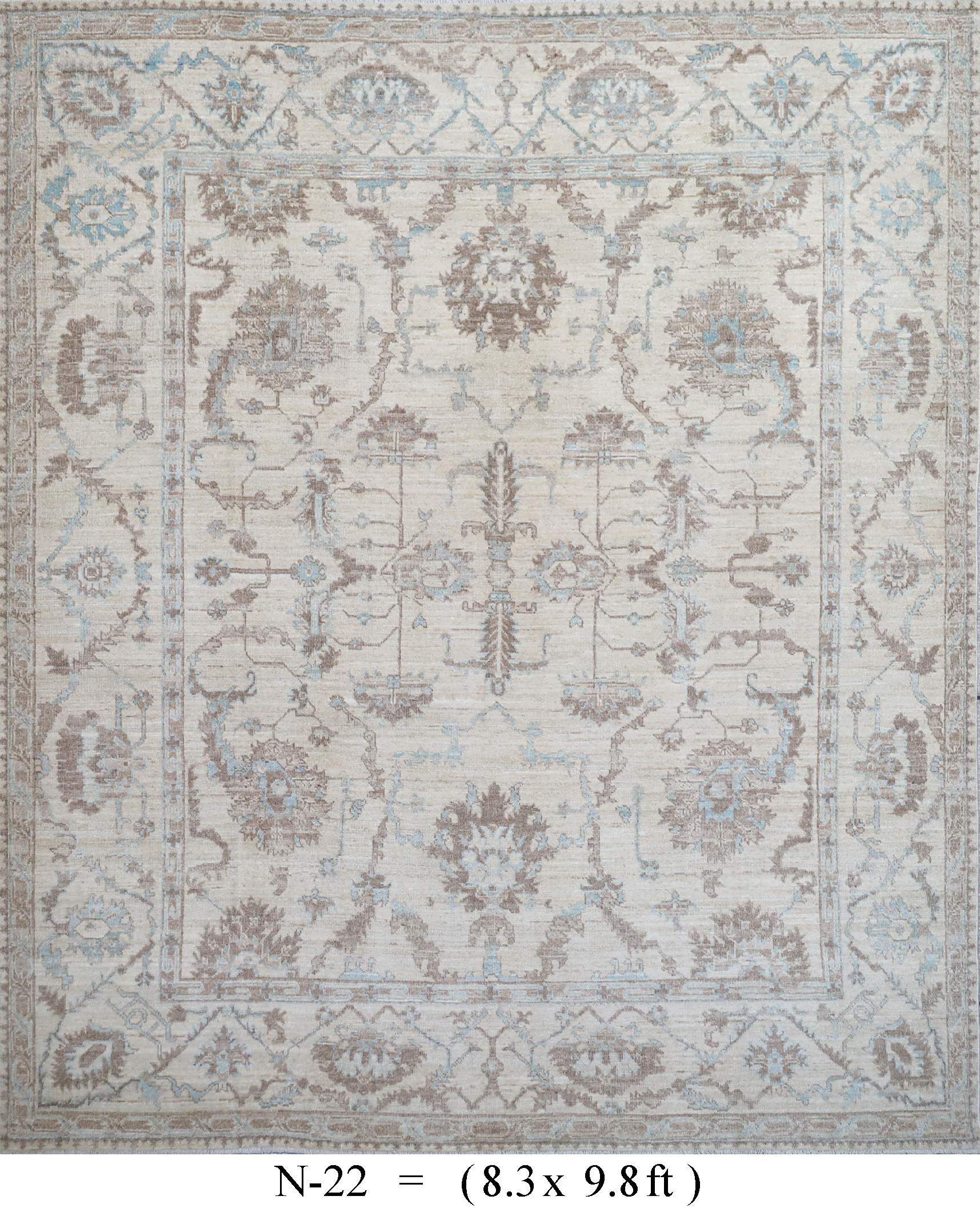 Pale vintage rug with ornate floral medallion pattern in cream, blue, and beige.
