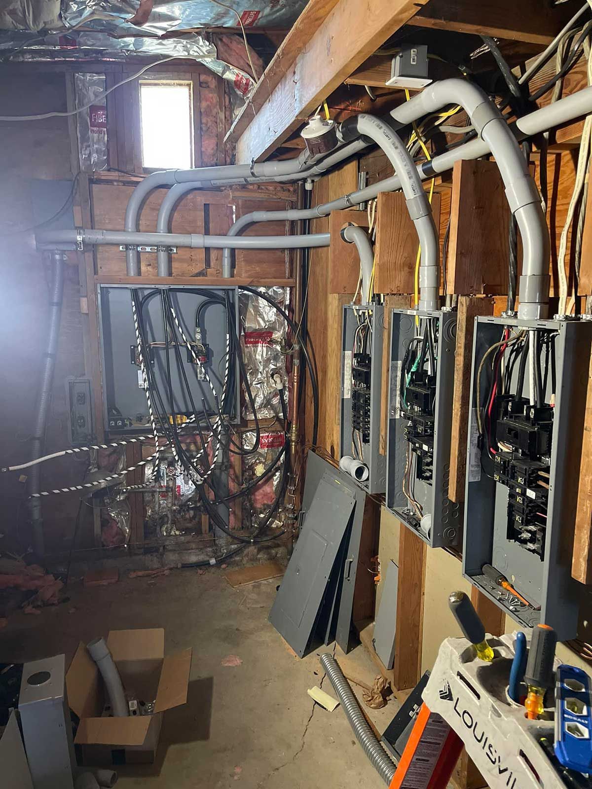 A room with a lot of wires hanging from the ceiling.