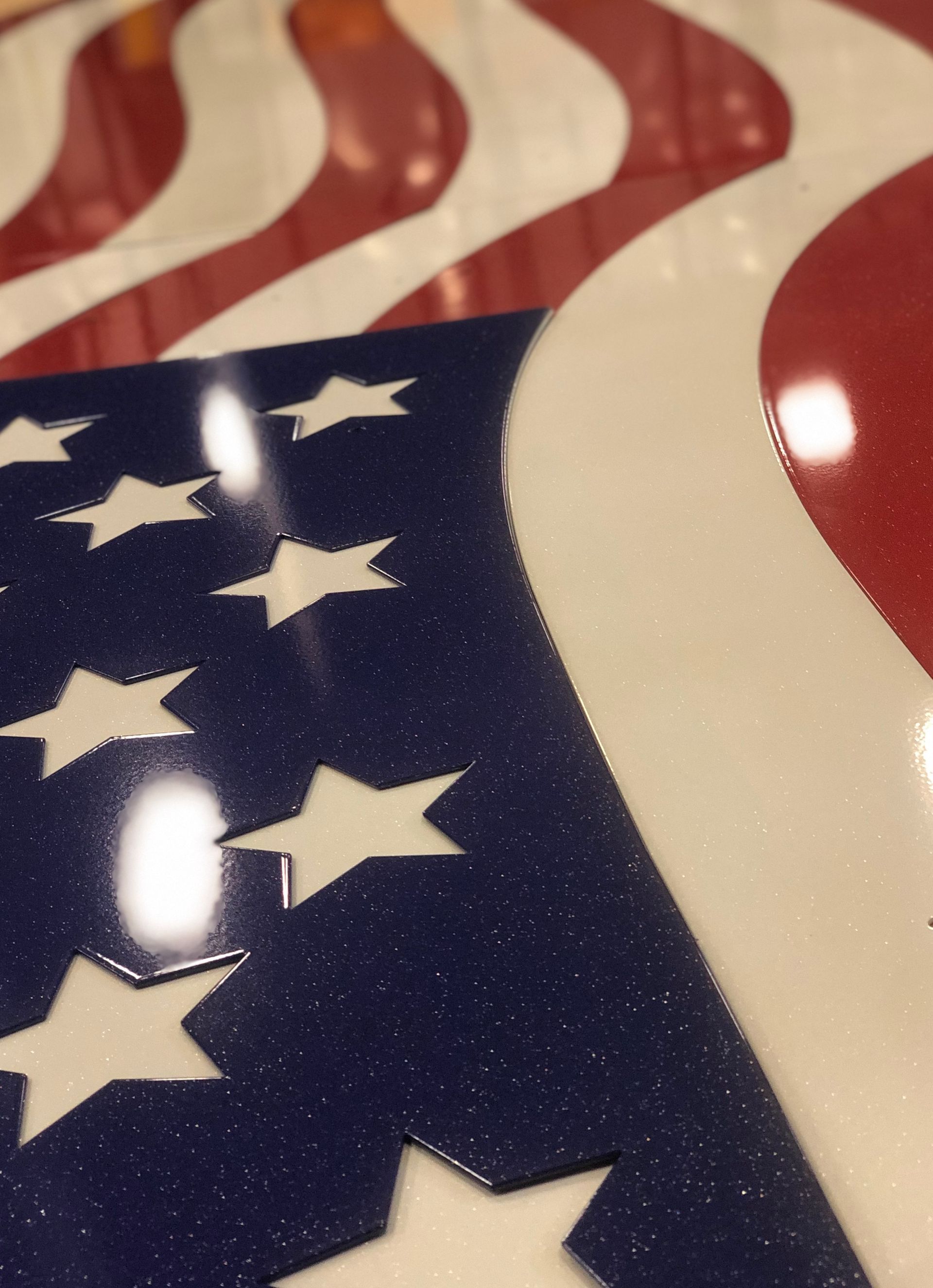 Close-up of a wavy American flag pattern with stars and red-and-white stripes
