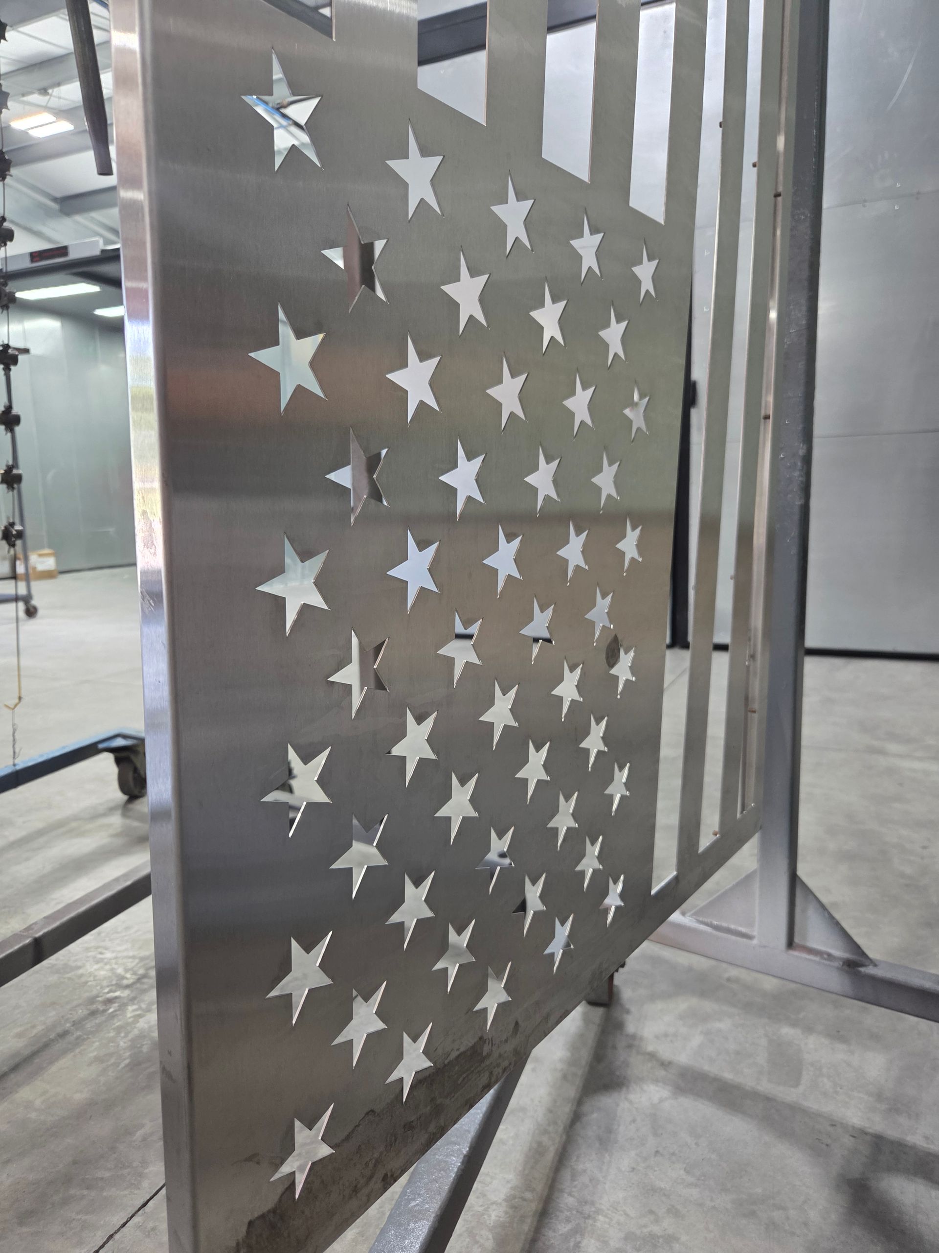 Metal panel with star-shaped cutouts in an industrial indoor setting