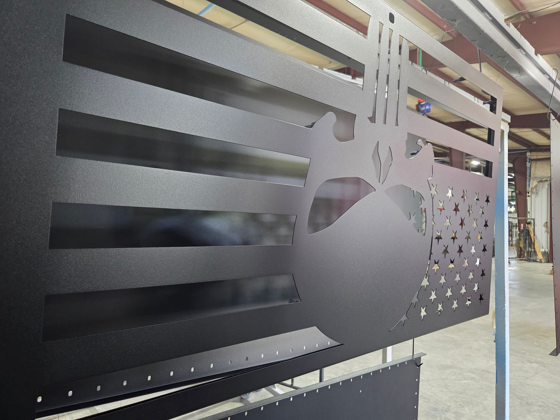 Black frosted glass door with a perforated apple logo in an office or retail hallway