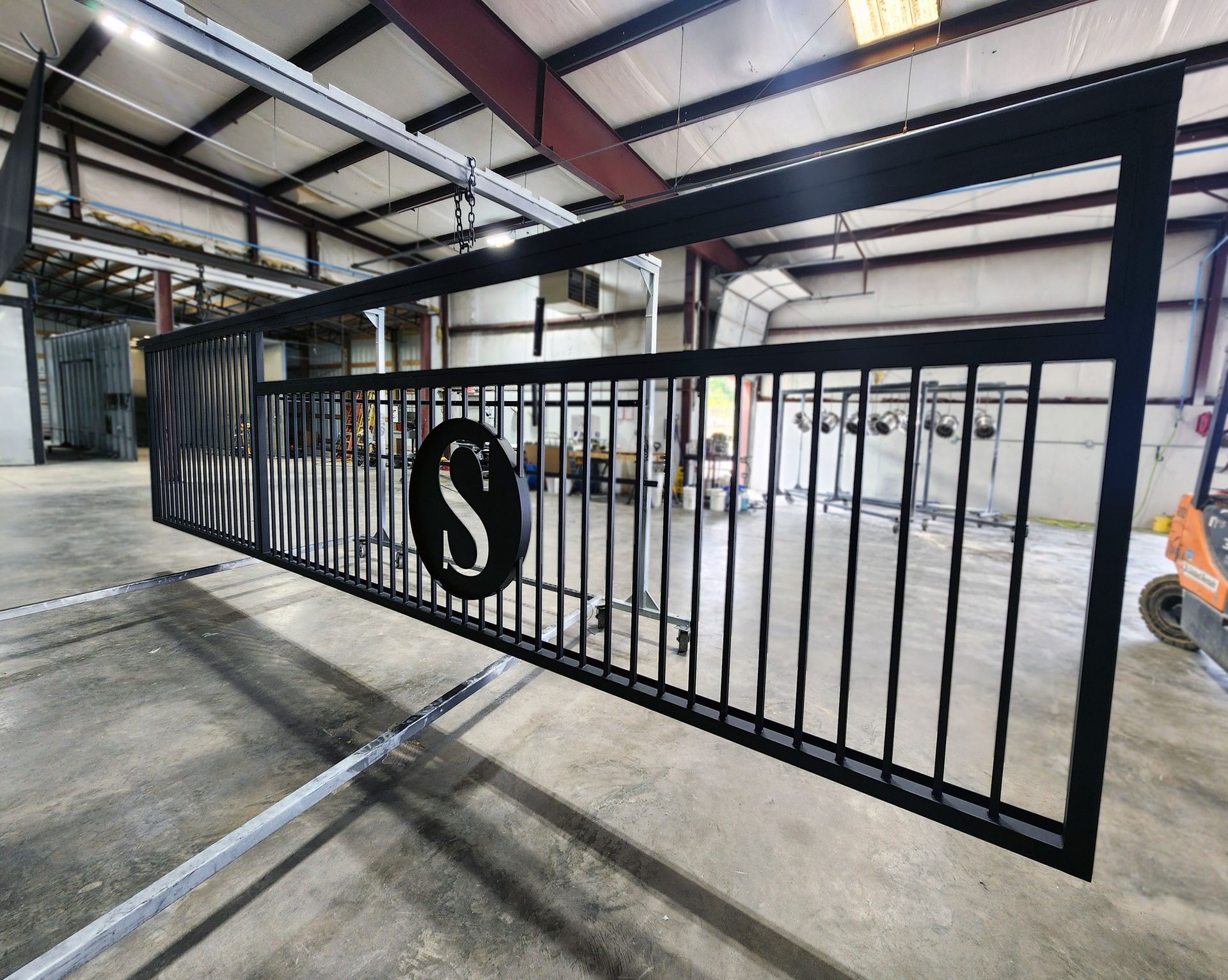 Black metal gate with a circular 