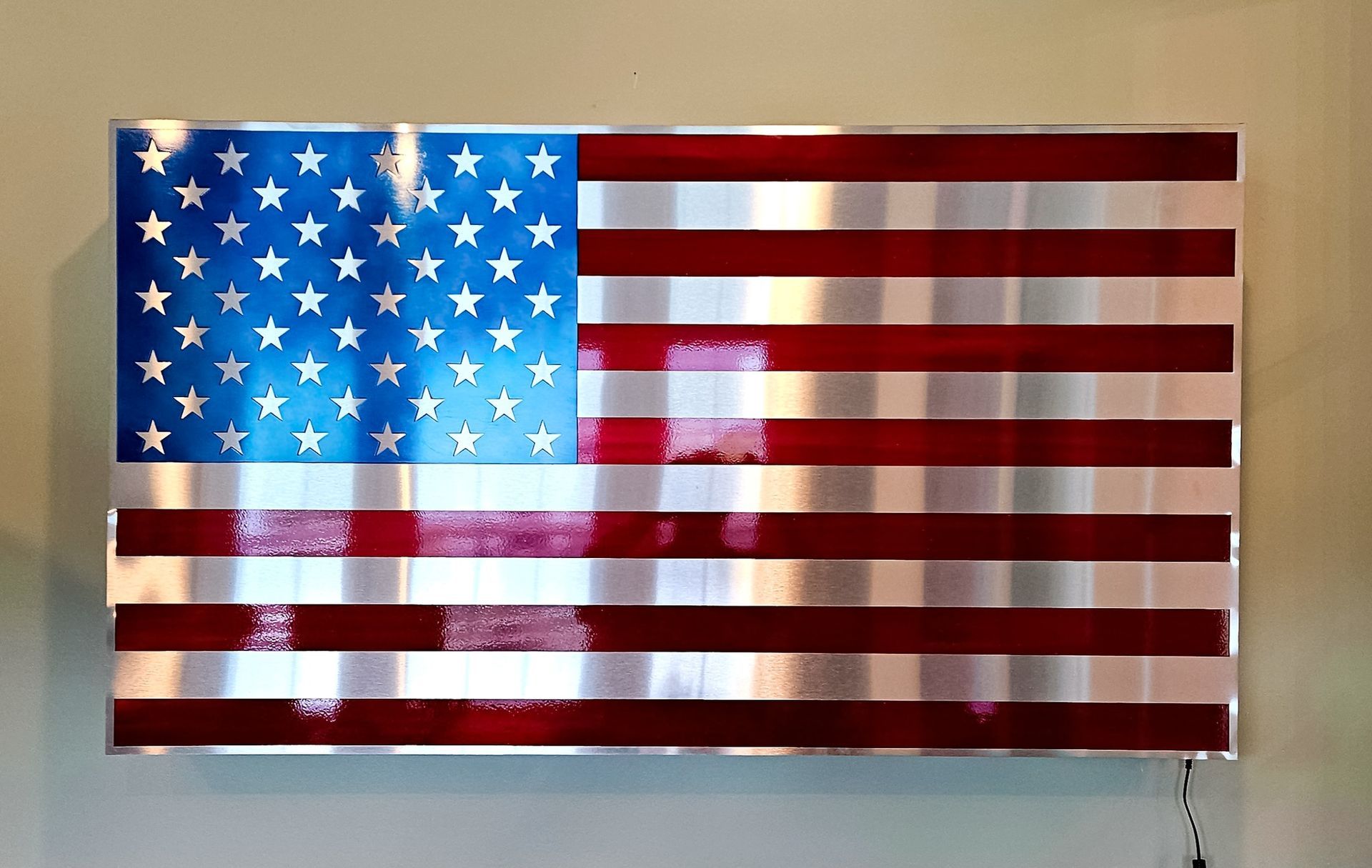 American flag mural with a blue field of stars and red-and-white stripes on a wall