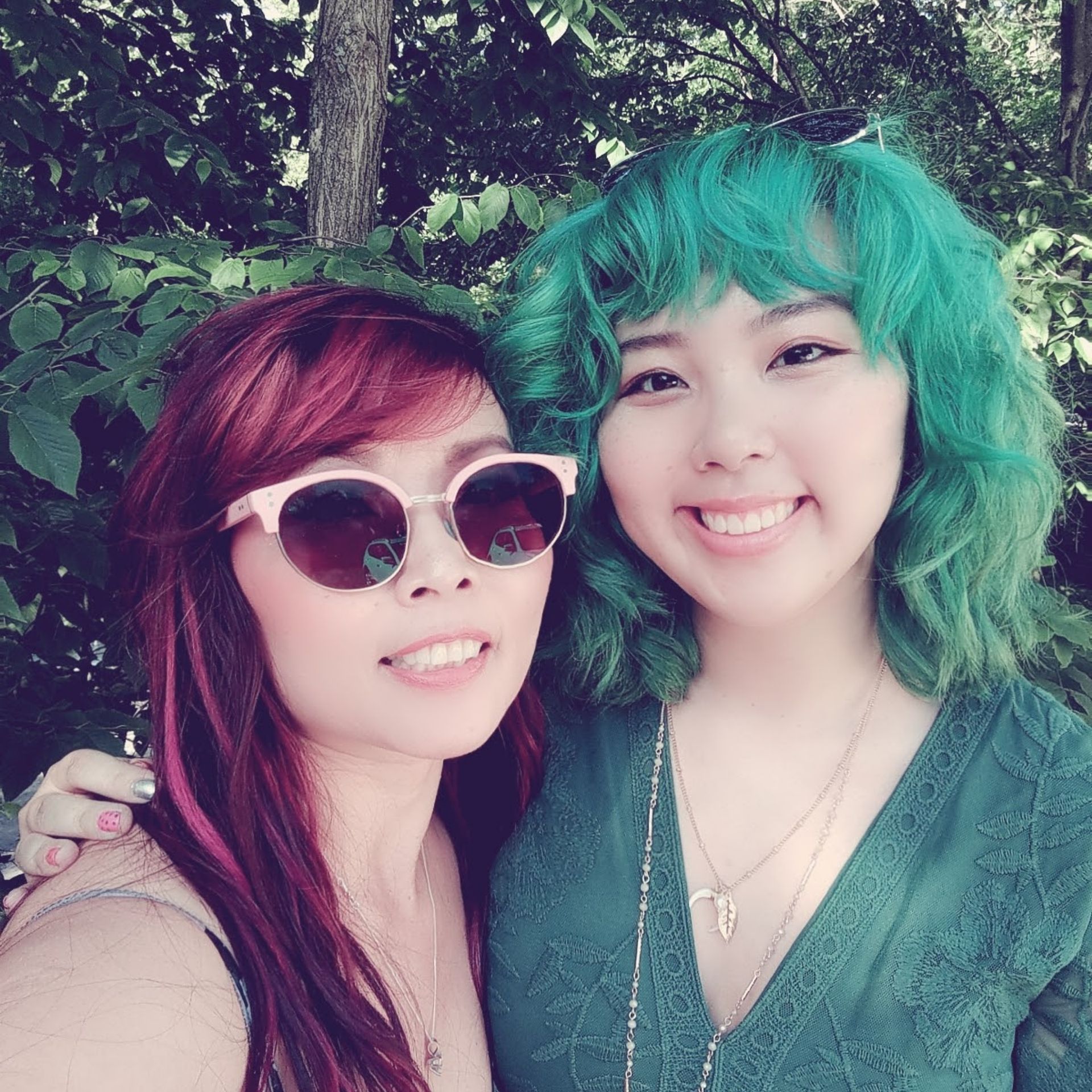two women with red hair and green hair are posing for a picture
