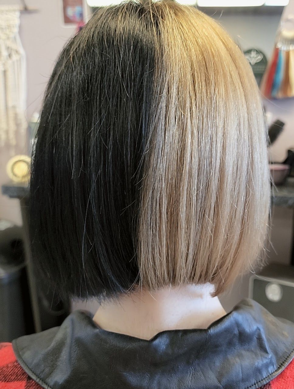 the back of a woman's head with half black and half blonde hair