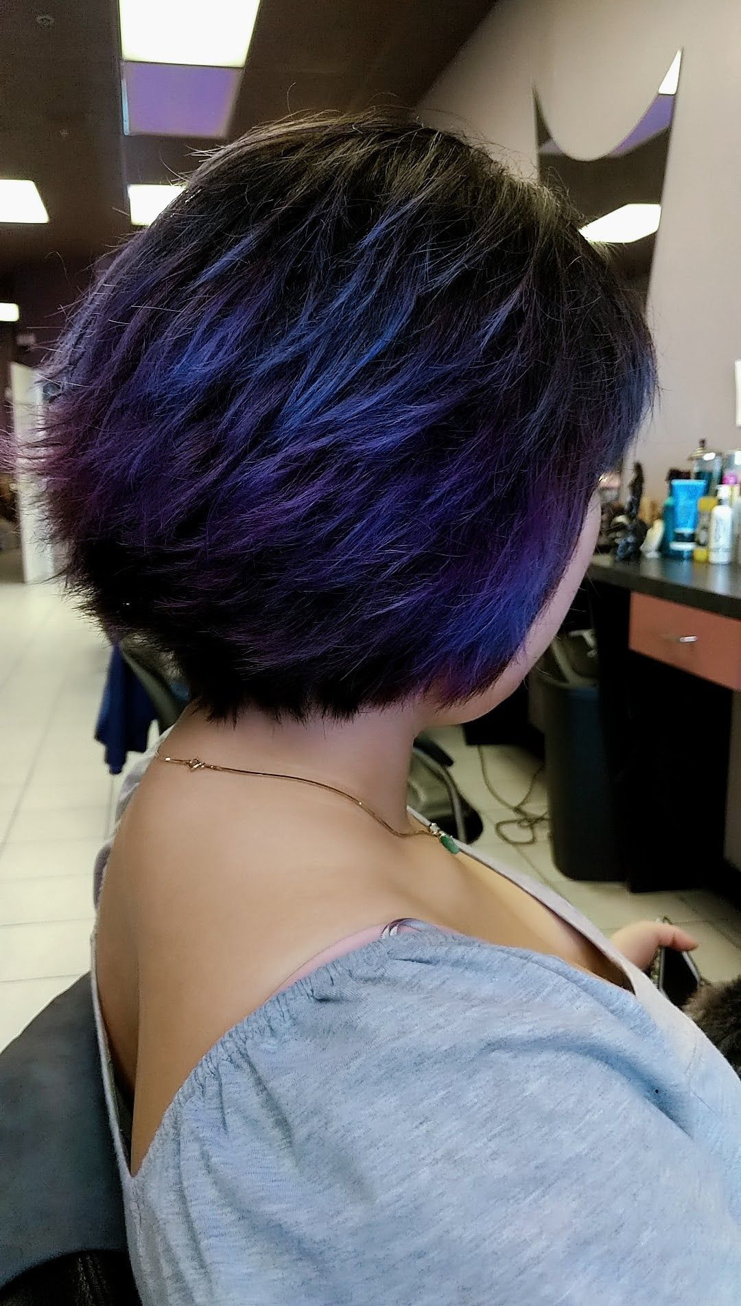 a woman with purple hair highlights