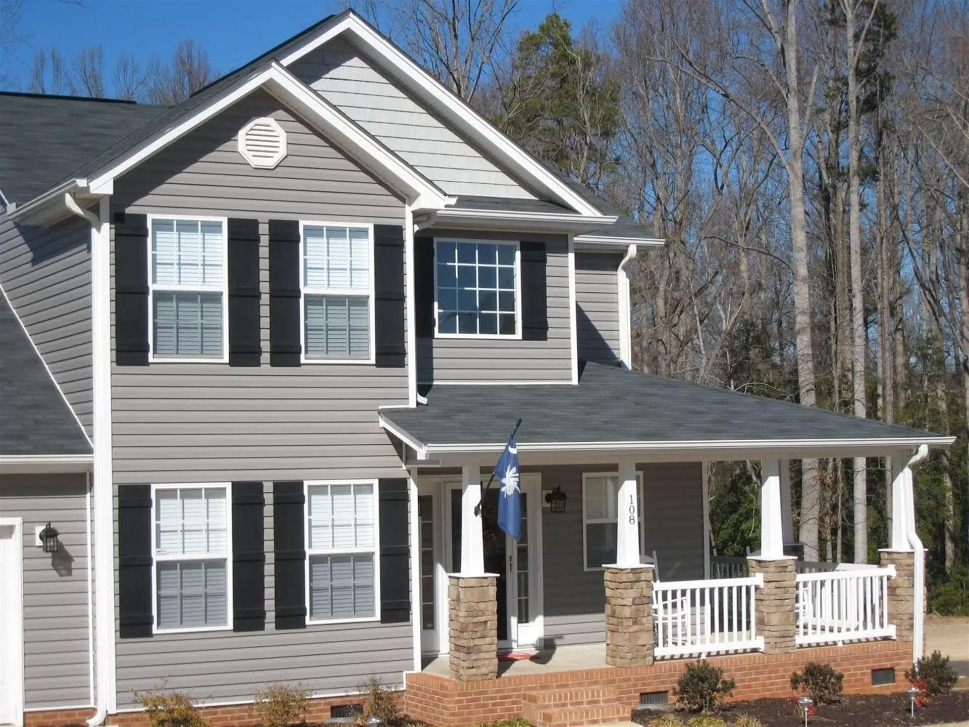 A house with a porch and a flag on it
