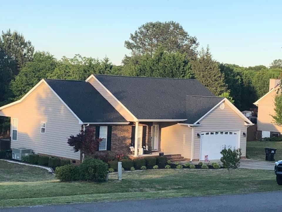 A house with a jeep parked in front of it