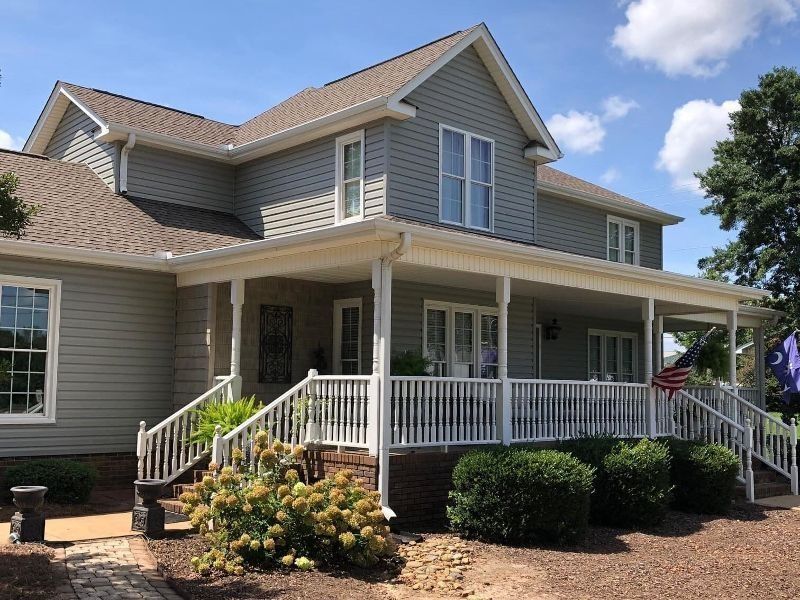 A large house with a large porch and stairs