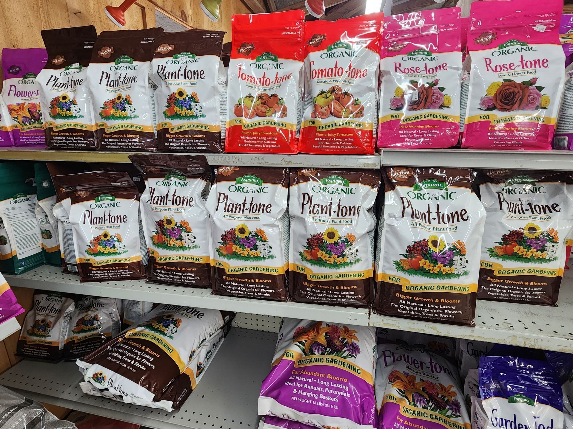 Shelves stocked with colorful packaged pet food bags in a store aisle