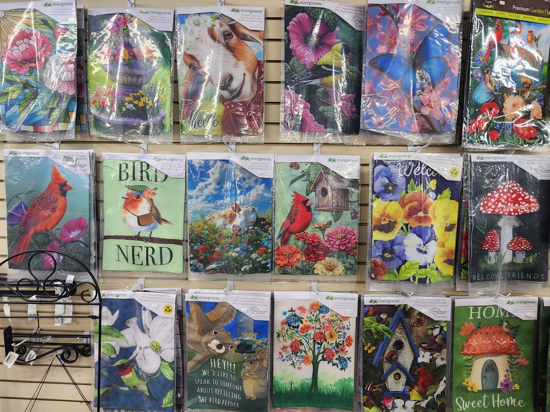 Colorful handmade Easter cards with rabbits, flowers, and spring scenes displayed in a craft shop window