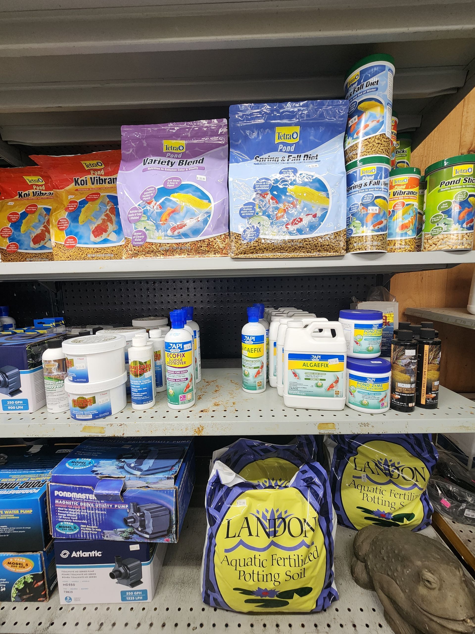 Store shelf stocked with colorful laundry and cleaning products in plastic tubs and bags